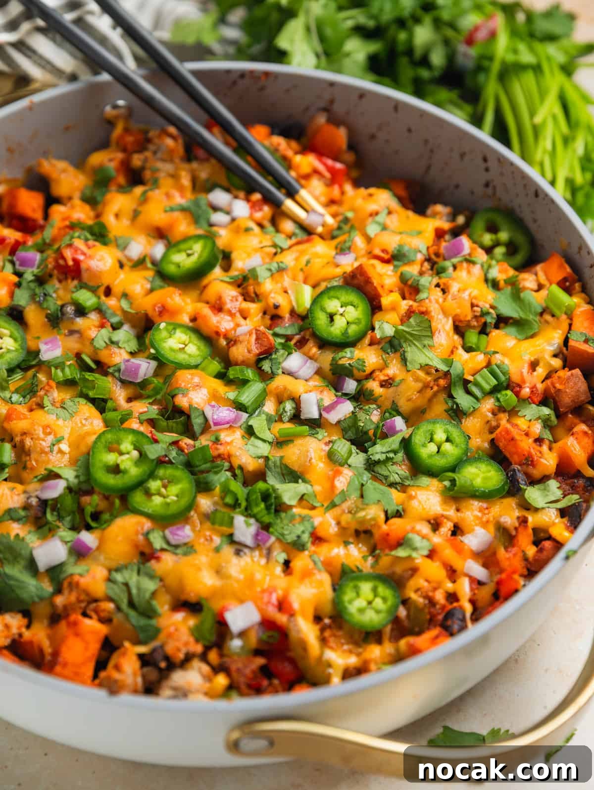 One-Pan Ground Turkey and Sweet Potato Skillet 2 Ground turkey and sweet potato skillet dinner in skillet topped with jalapeños, cilantro, onion and more.