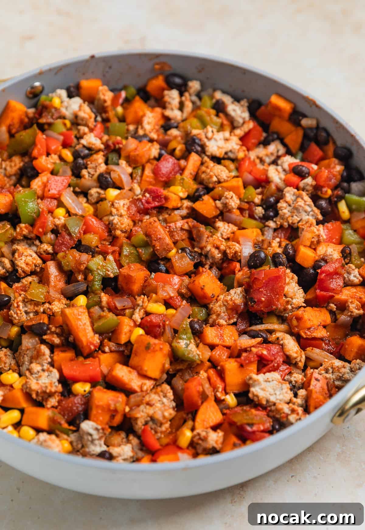One-Pan Ground Turkey and Sweet Potato Skillet 9 Turkey and pepper mixture stirred into sweet potato, bean, corn mixture in skillet.