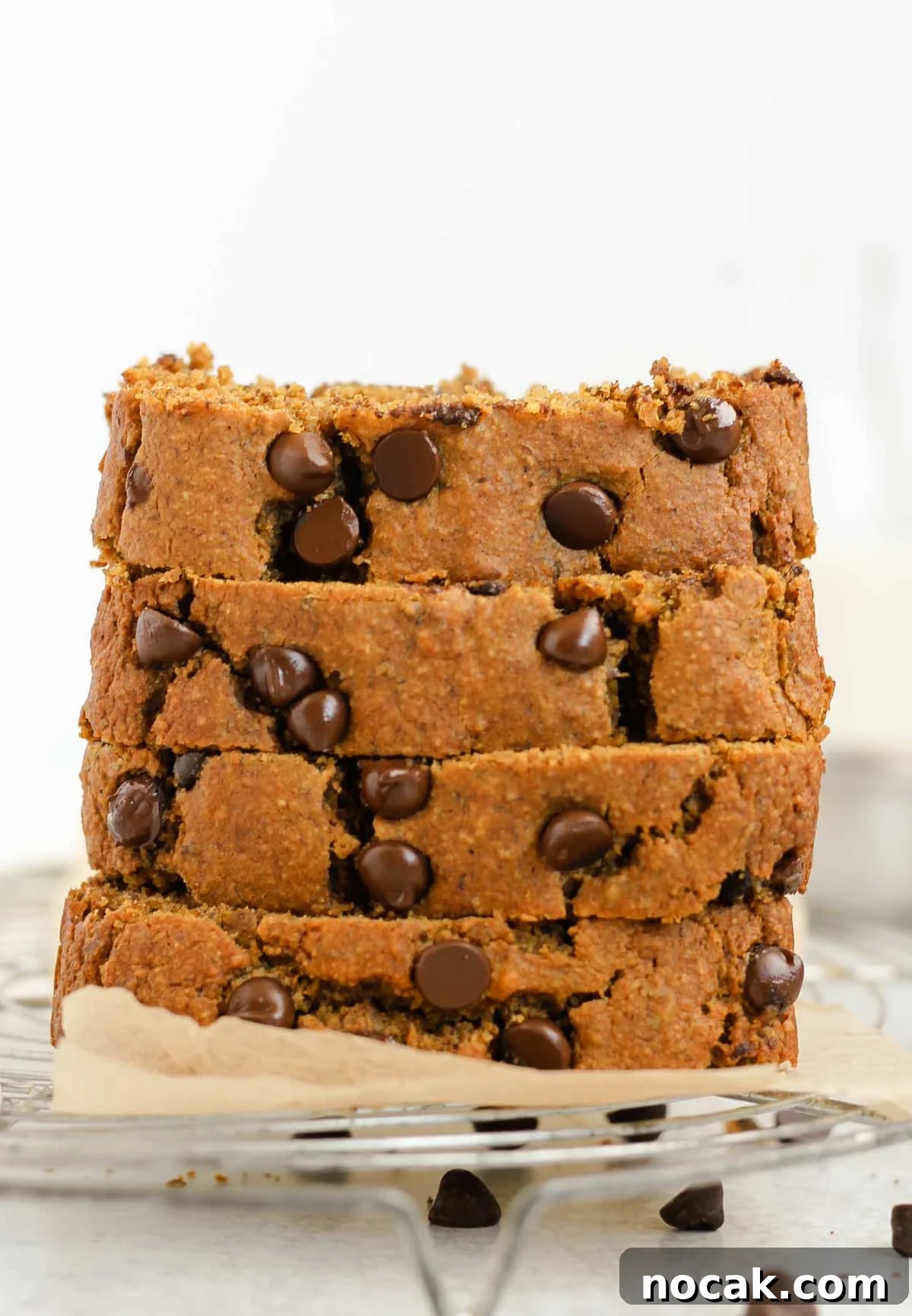 Four pieces of pumpkin chocolate chip bread stacked.