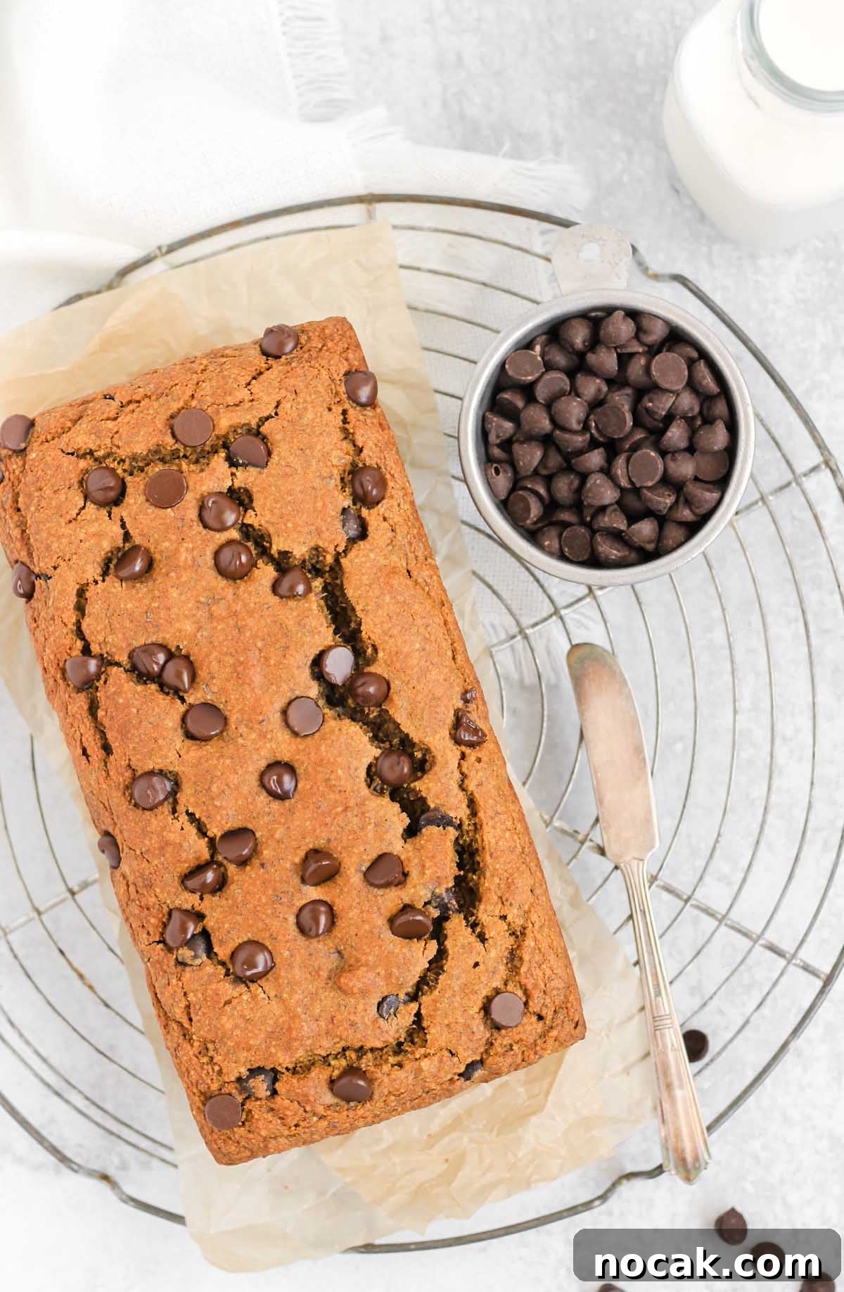 Gluten-free pumpkin chocolate chip loaf on a round wire cooling rack.