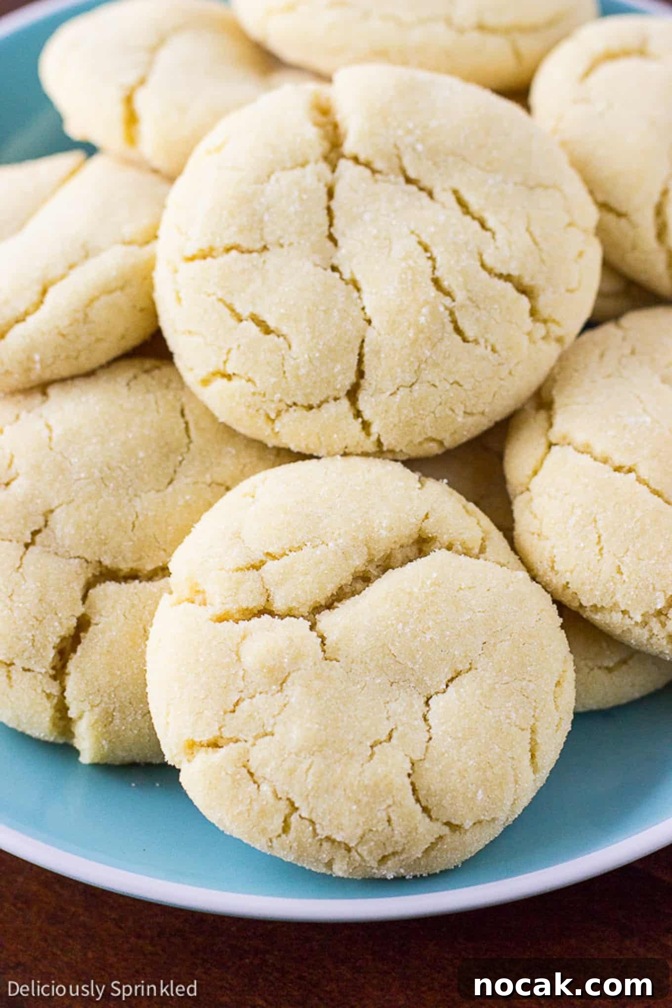 Classic Soft Sugar Cookies Recipe 2 Soft sugar cookies stacked on top of each other on a plate.