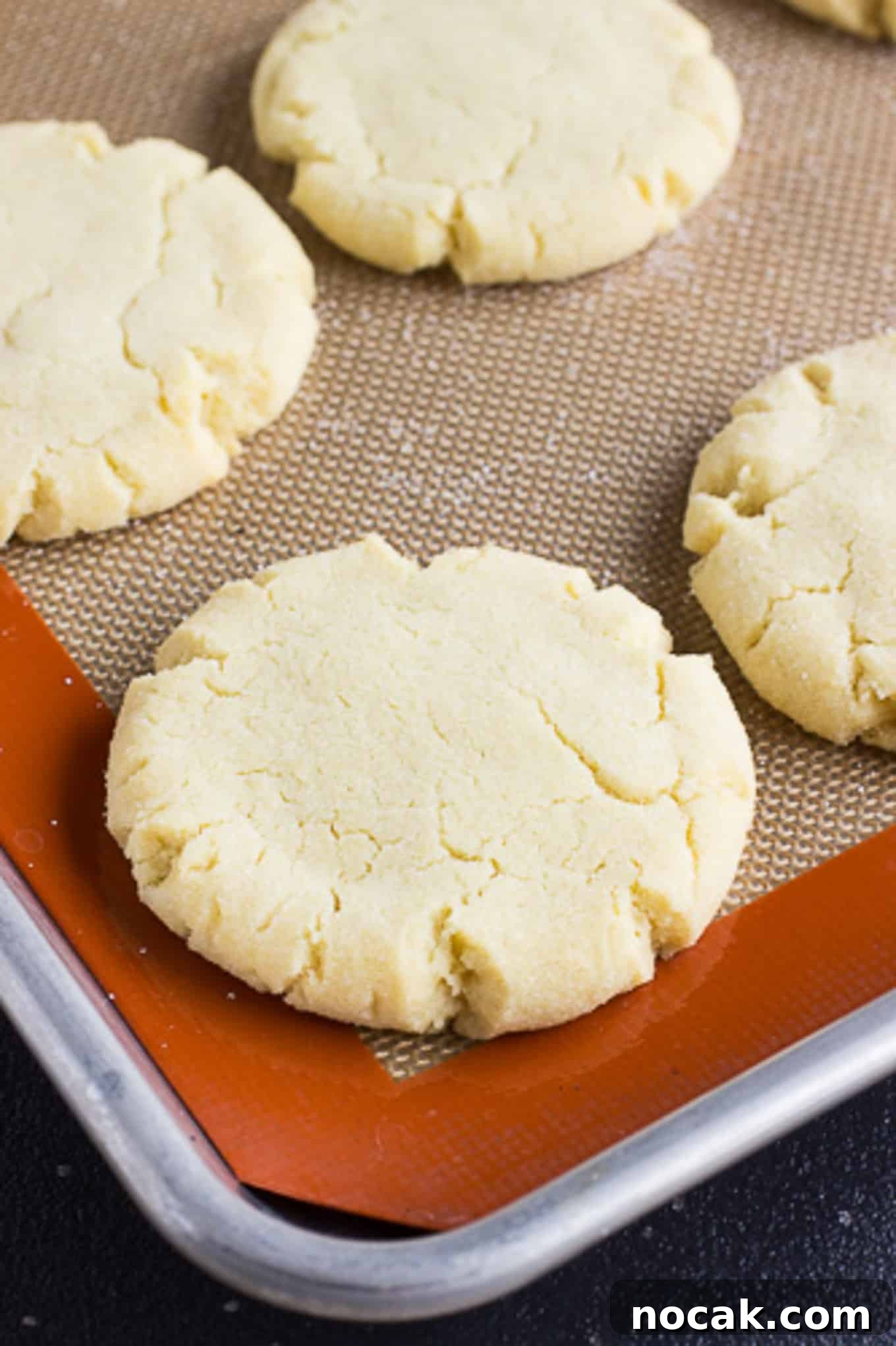 Classic Soft Sugar Cookies Recipe 3 A close up of easy sugar cookies on a baking tray with a silpat.