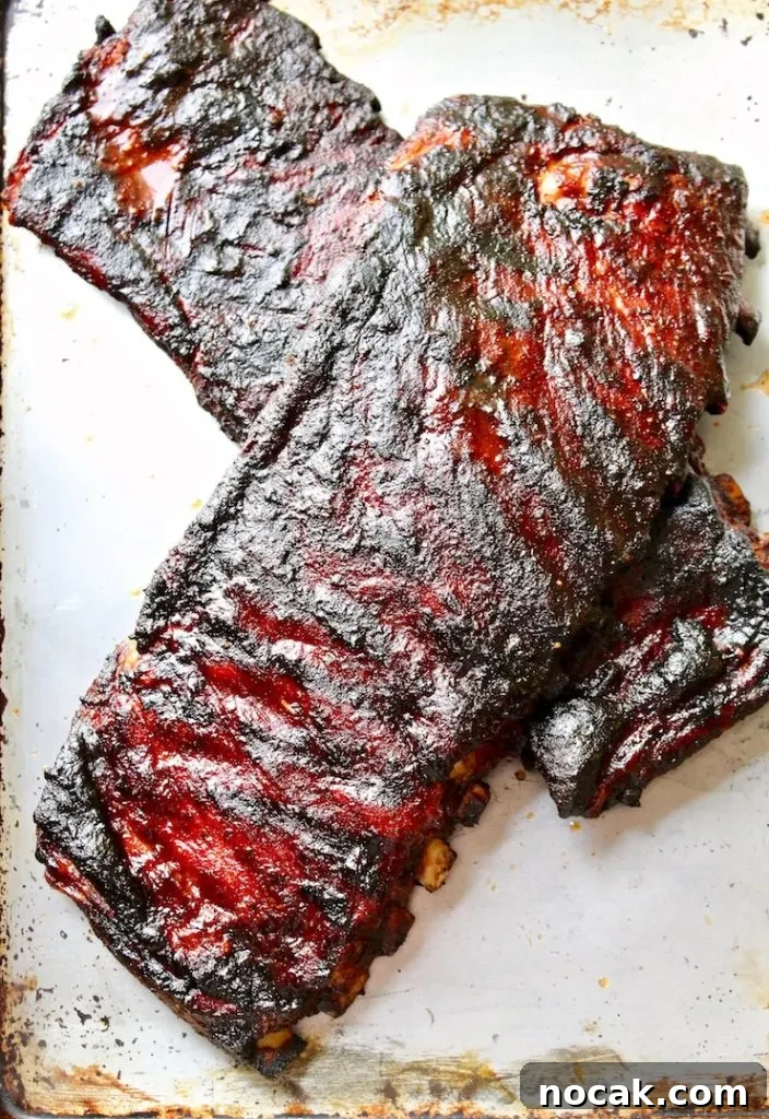 St. Louis-Style BBQ Ribs Recipe for Tender, Sticky Glaze 3 Two slabs of cooked St. Louis style ribs.