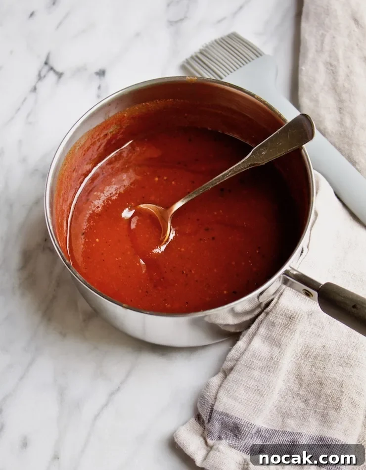 St. Louis-Style BBQ Ribs Recipe for Tender, Sticky Glaze 5 Homemade BBQ sauce in pan with brush.