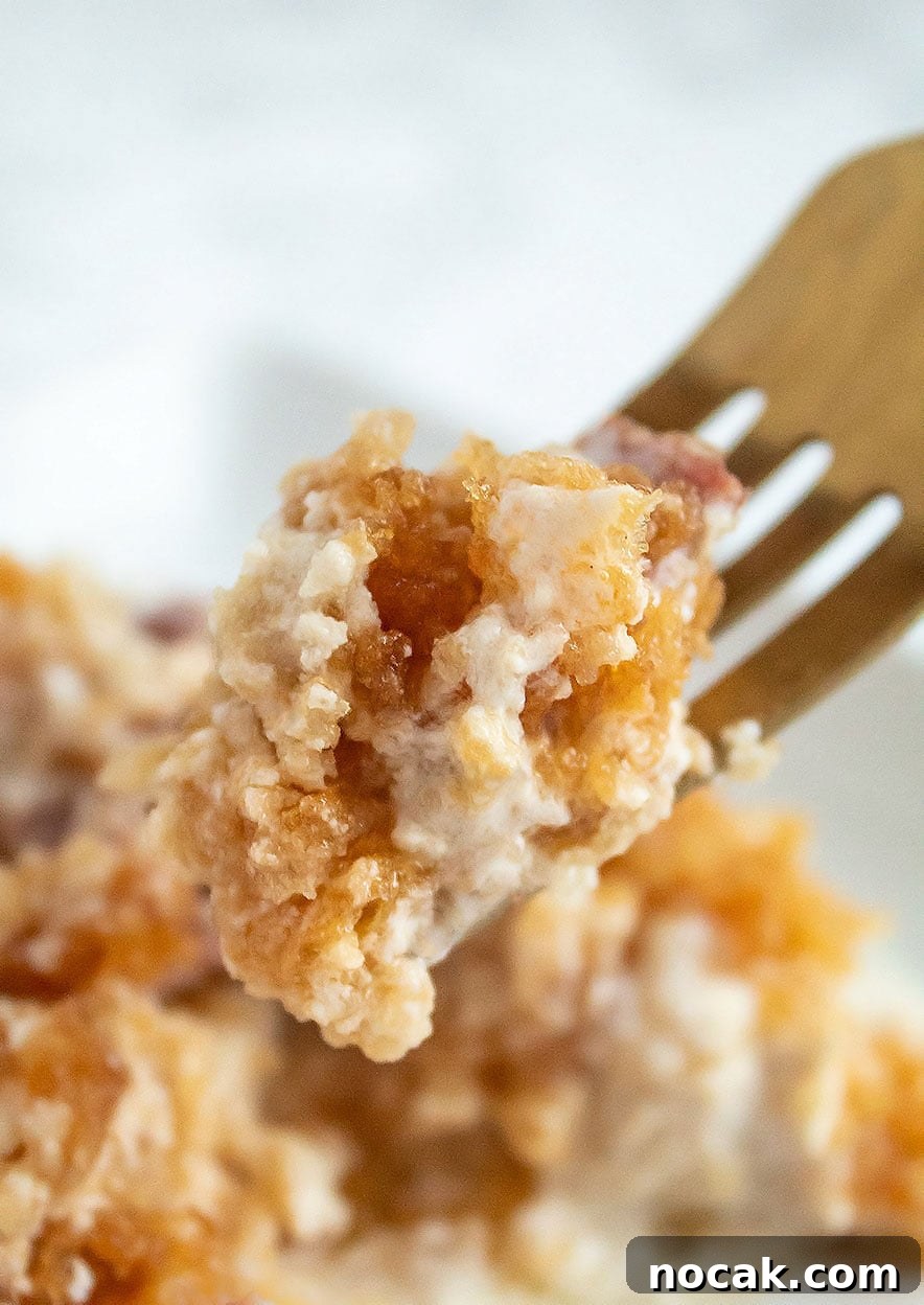 Ritzy Keto Chicken Casserole with Crispy Pork Rind Topping 3 closeup of keto casserole bite stuck to a gold fork