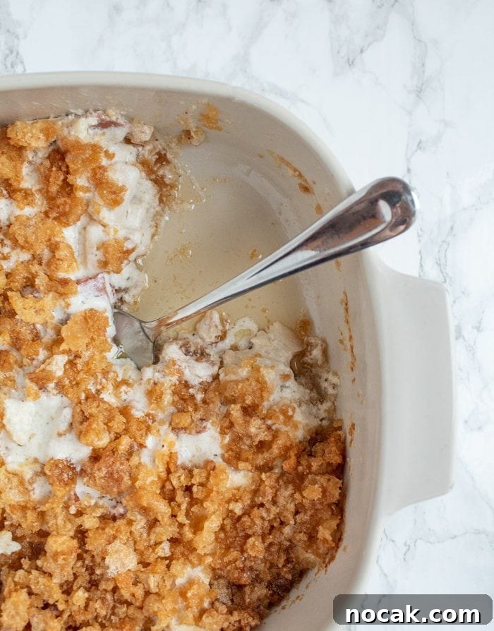 Ritzy Keto Chicken Casserole with Crispy Pork Rind Topping 8 keto casserole dish with piece missing and butter on the bottom