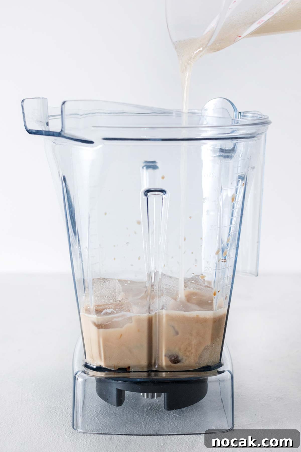 Homemade Starbucks Espresso Frappuccino Recipe 5 Espresso, instant coffee, milk, ice, and homemade Frappuccino base syrup in a blender cup.