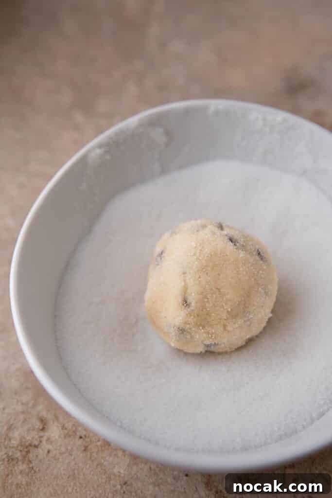 Bakery-Style Soft and Chewy Chocolate Chip Sugar Cookies 7 Cookie dough ball rolled in granulated sugar