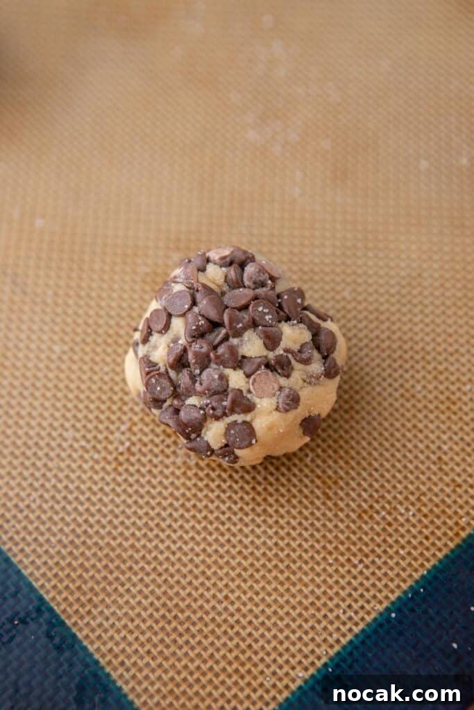 Bakery-Style Soft and Chewy Chocolate Chip Sugar Cookies 8 Cookie dough ball coated in mini chocolate chips