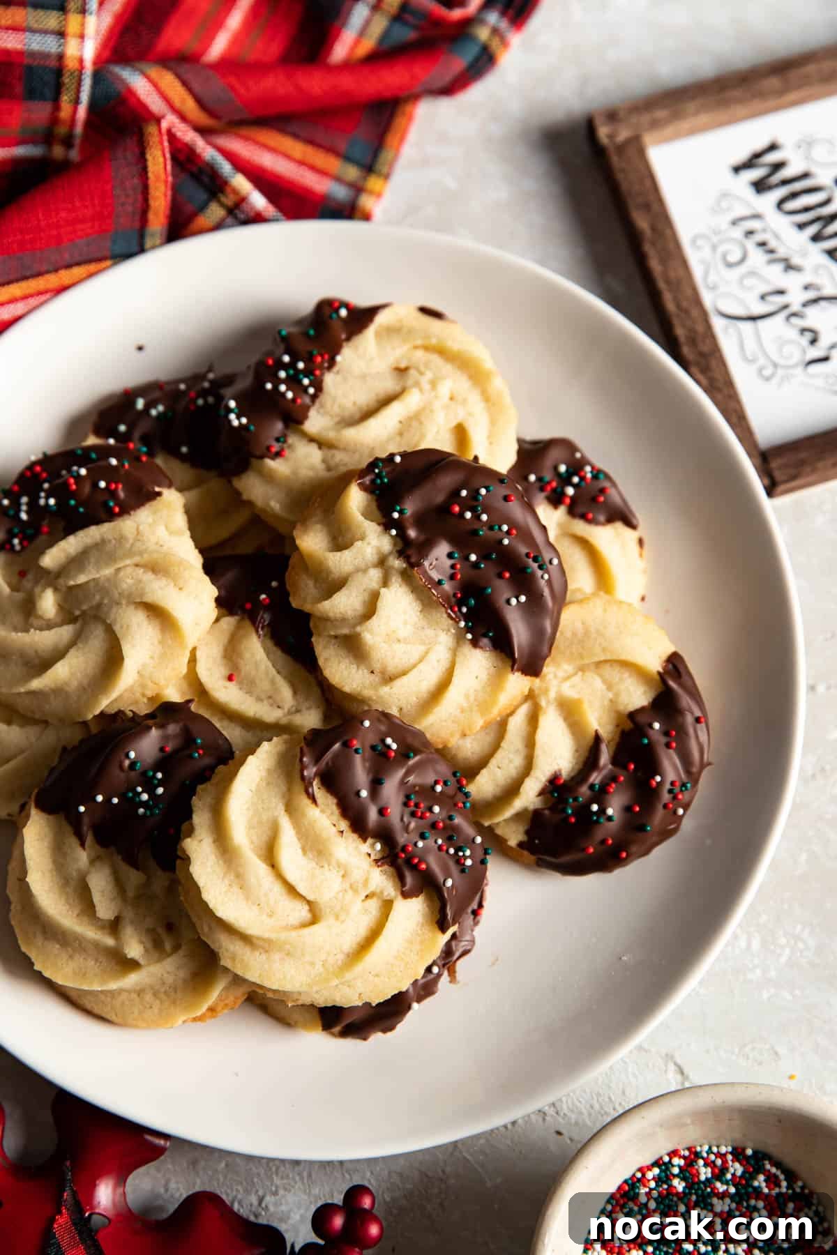 Classic Chocolate-Dipped Butter Cookies Recipe 7 chocolate dipped cookies on a plate.