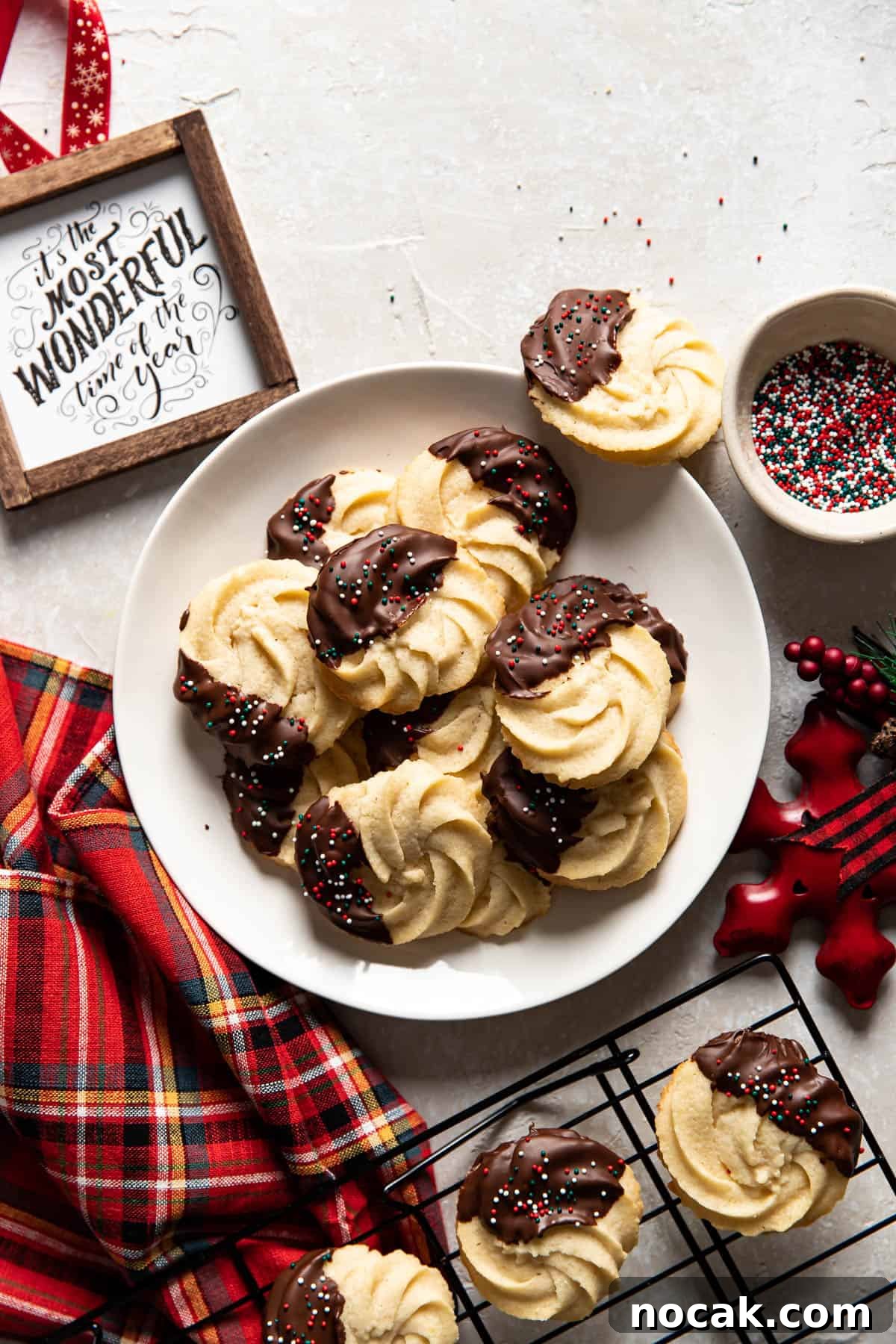 Classic Chocolate-Dipped Butter Cookies Recipe 8 chocolate dipped cookies on a plate.